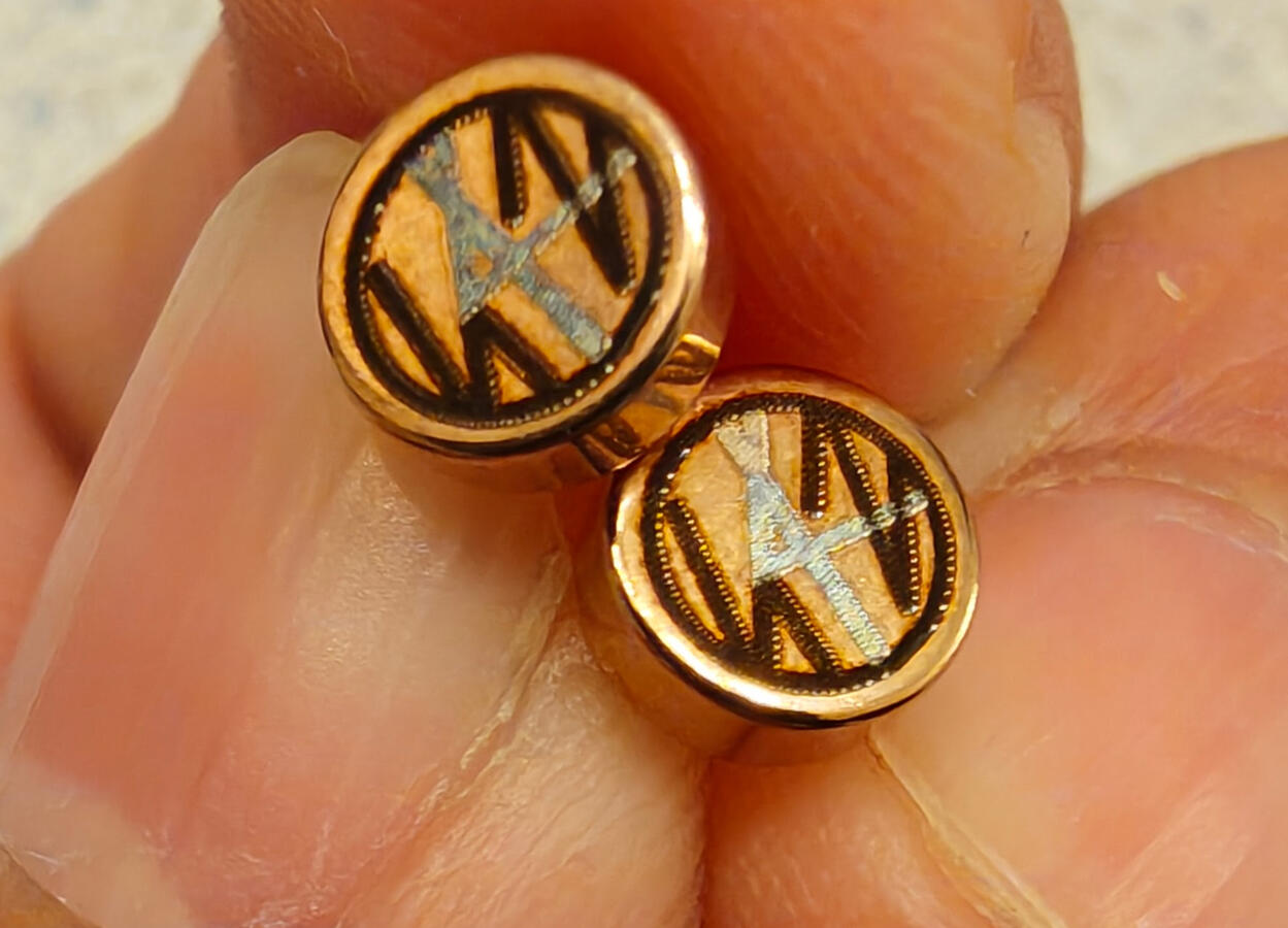 Rose gold earrings with dark and light engraving.