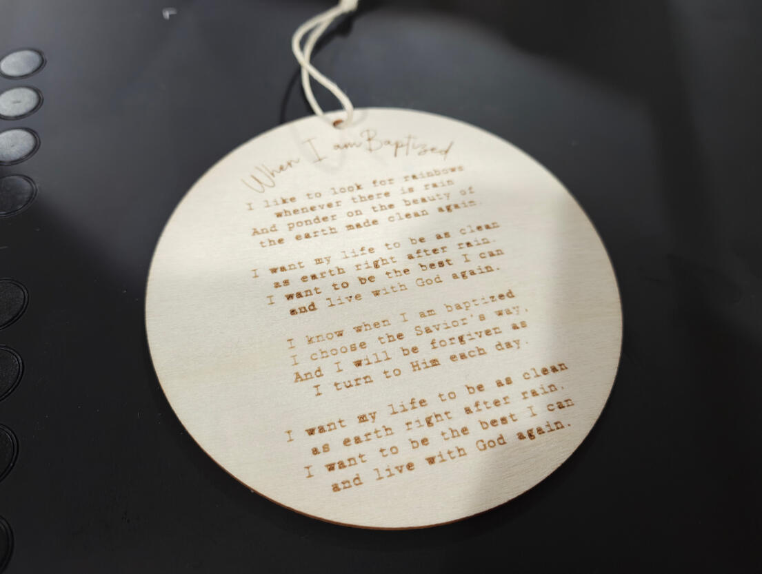 Song lyrics on a wood ornament.